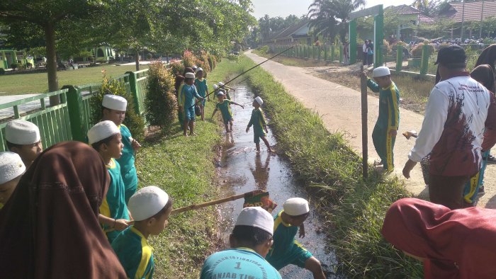 Siswa MIN 1 Tanjab Timur Bersihkan Selokan Madrasah